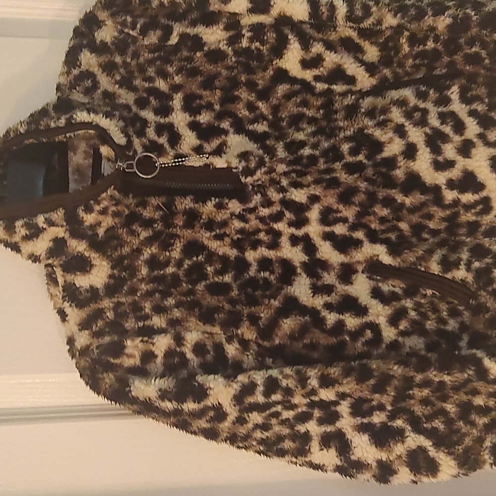 Cuddly Sherpa leopard animal skin black and cream winter jacket for girls.